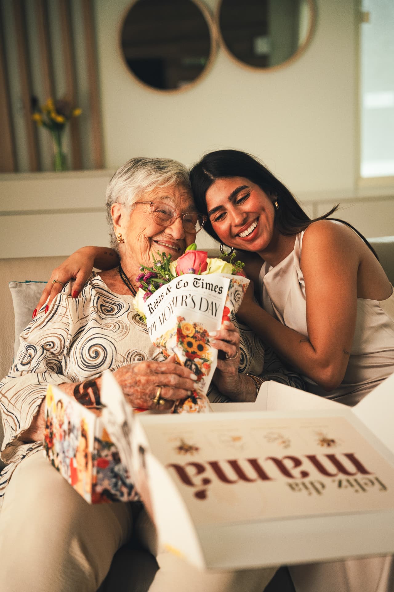 Mother and daughter smiling with a Rosas & Co. Mother's Day bouquet